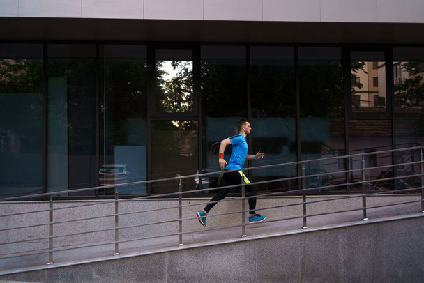 Attractive fit man running in the city - Fotó, kép