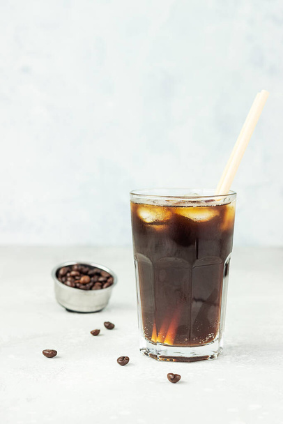 Espresso tonic, refreshment summer drink with tonic water, coffee and ice cubes, light grey background. Trendy coffee drink. - Φωτογραφία, εικόνα