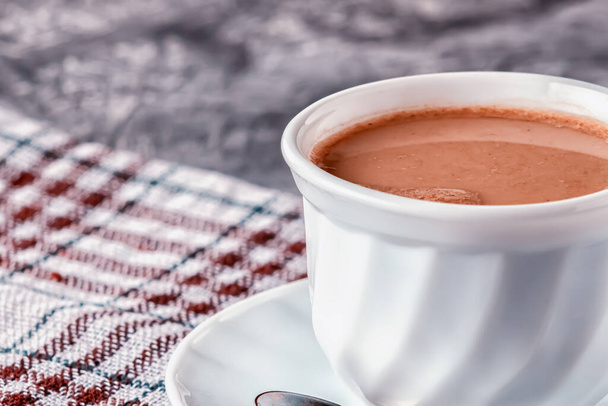 On a gray background, freshly brewed aromatic coffee with cream - Фото, зображення