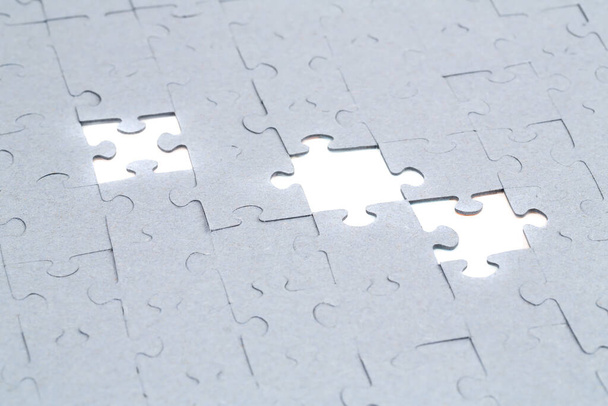 Unfinished jigsaw puzzle pieces on white background. - Photo, Image