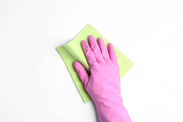 Person in rubber glove with rag on white background, closeup of hand - Zdjęcie, obraz