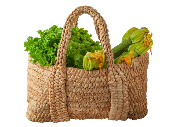 Straw basket or bag with fresh vegetables on white background - Photo, Image