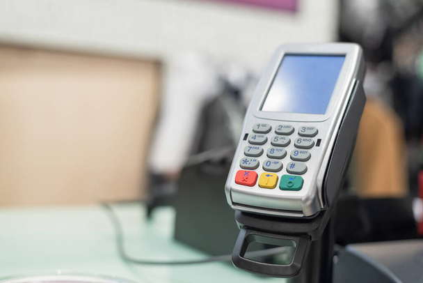 Payment pos terminal on a store counter background. - Photo, image