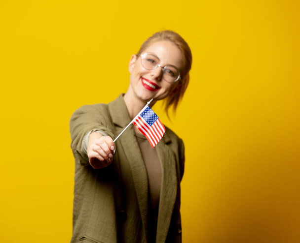 Style blonde woman in jacket with flag of USA on yellow background - Foto, immagini
