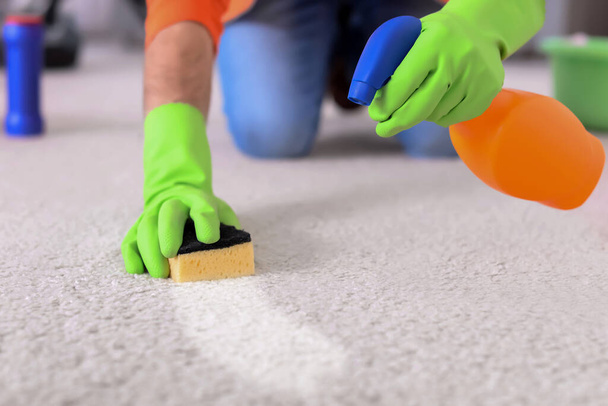 Man removing dirt from carpet at home, closeup. Cleaning service - Foto, Imagem