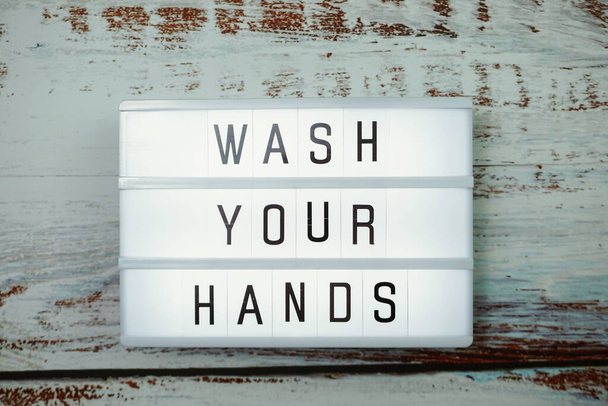 Wash Your Hands word in light box top view on wooden background - Fotoğraf, Görsel