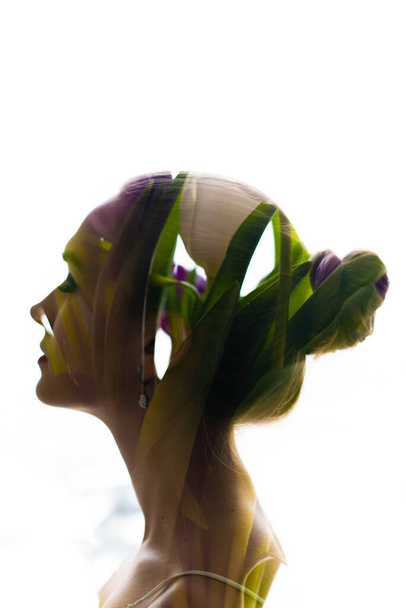 The concept of ecology, concern for the environment and nature. Double exposure portrait of young woman and tulip flowers and leaves - Photo, Image