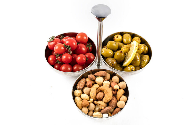 olives and tomato with nuts on white background, Snack Food - Foto, Imagem