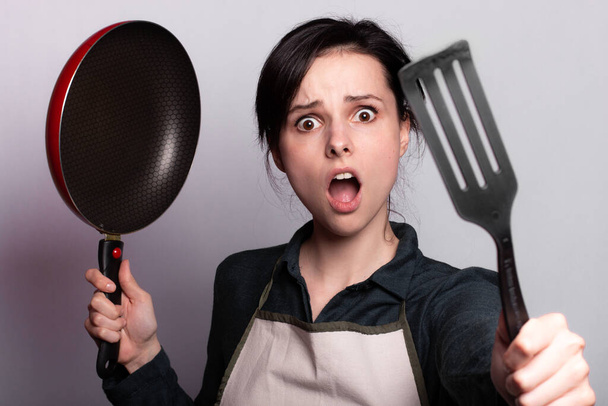 woman cooking dinner, kitchen, grey background - Foto, Imagem