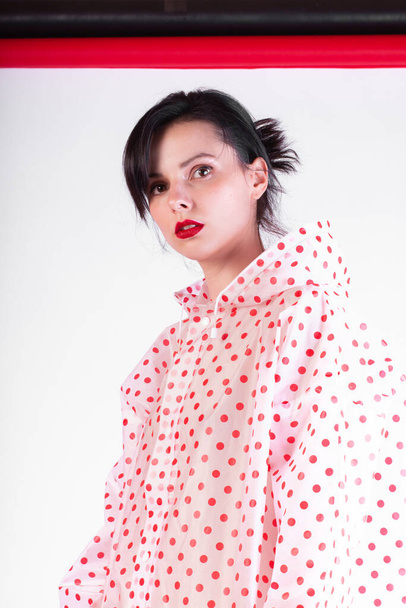 fashionable girl with red lips in a raincoat - Valokuva, kuva
