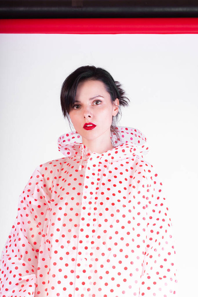 fashionable girl with red lips in a raincoat - Φωτογραφία, εικόνα