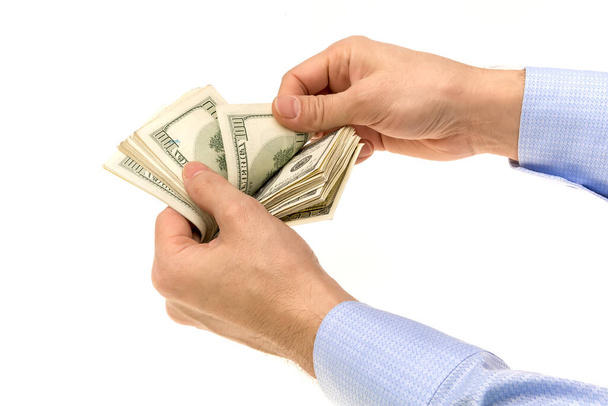 Рука тримає американський долар на білому тлі
 - Фото, зображення