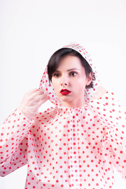beautiful woman with red lips in a raincoat  - Φωτογραφία, εικόνα