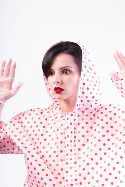beautiful woman with red lips in a raincoat  - Valokuva, kuva
