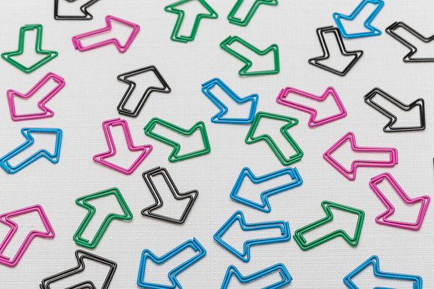 colorful arrow-shaped  paper clips on white background - Foto, Imagem