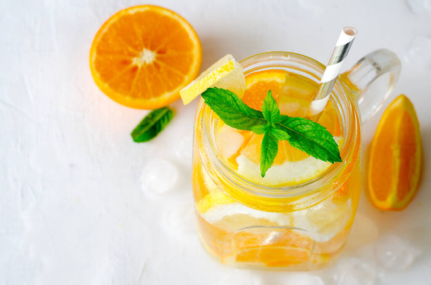 Summer refreshing iced drinks with orange, lemonand mint on white background - Valokuva, kuva