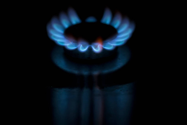 голубая газовая горелка на темном фоне - Фото, изображение