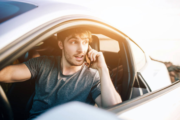 Trendy young men traveling by car. Relaxed happy man on summer roadtrip travel vacation - Photo, Image