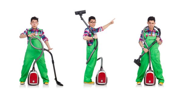 Funny man in green coveralls vacuum cleaning - Zdjęcie, obraz