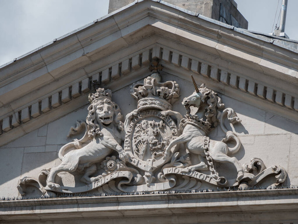 Antiguo edificio del Parlamento irlandés. Detalle de estatuas y escudo de armas británico en relieve. Esto es ahora el Banco de Irlanda en Dublín
. - Foto, imagen