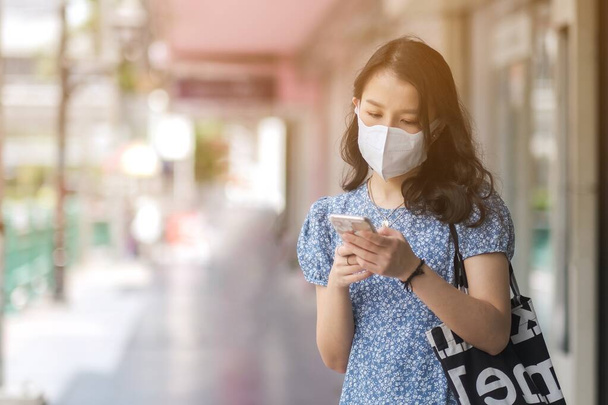 Asian woman wears a mask video called by smartphone  - Фото, зображення