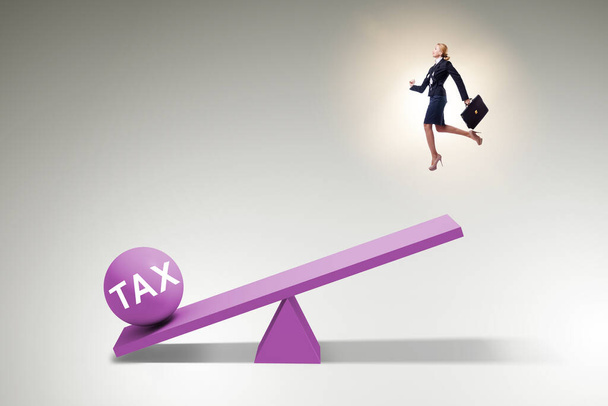 Businesswoman in tax concept with seesaw - Photo, Image