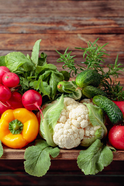 Various fresh raw vegetables on a old wooden background. - Photo, Image