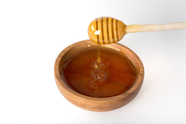 wooden dipper and honey isolated on white background  - Photo, Image