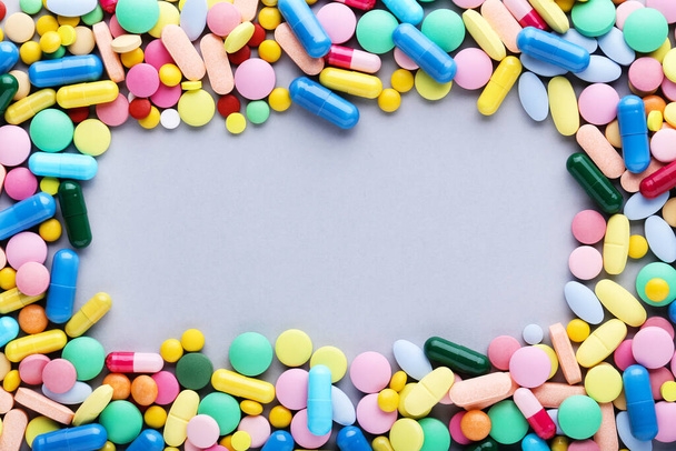 Colorful pills on grey background - Фото, изображение
