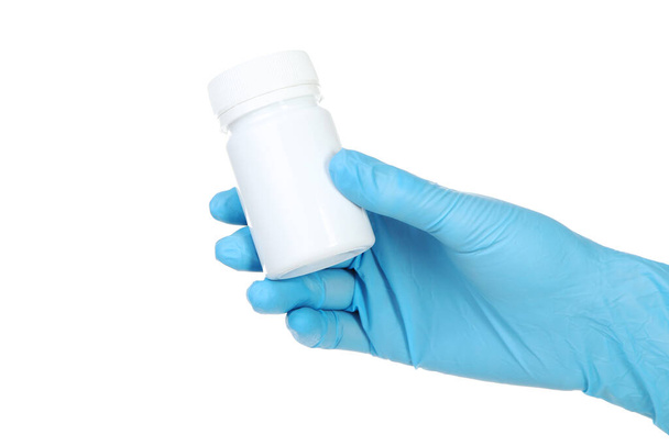 Doctor hand in glove holding medicine bottle on white background - Fotó, kép