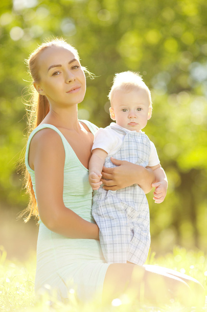 Cute little baby in summer park with mother on the grass. Swee - Photo, Image