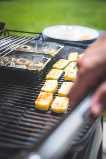 Close up of cheese and vegetables on gas grill. Summer time, outdoors. - Zdjęcie, obraz