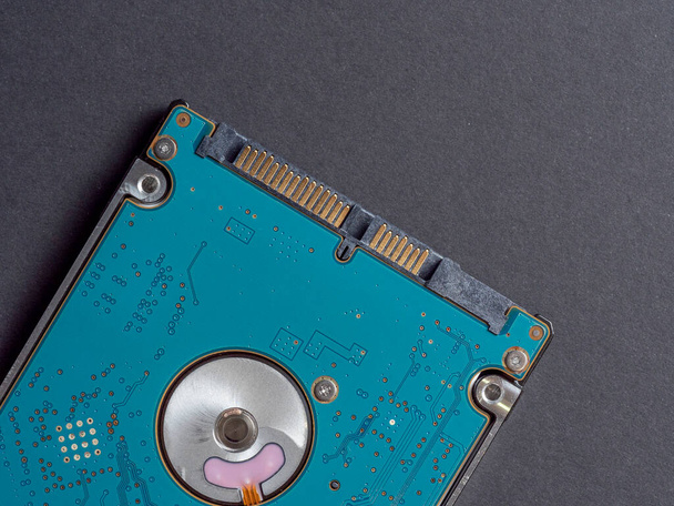 2.5 inch hard disk drive for laptop or computer on a dark paper background. Top view, flat lay - Photo, Image