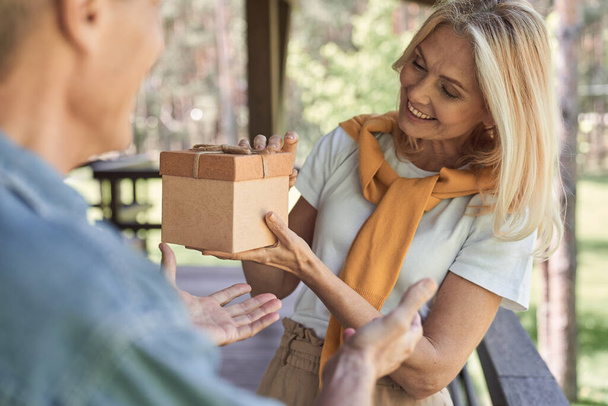 Happy woman getting gift in box from husband - Photo, Image