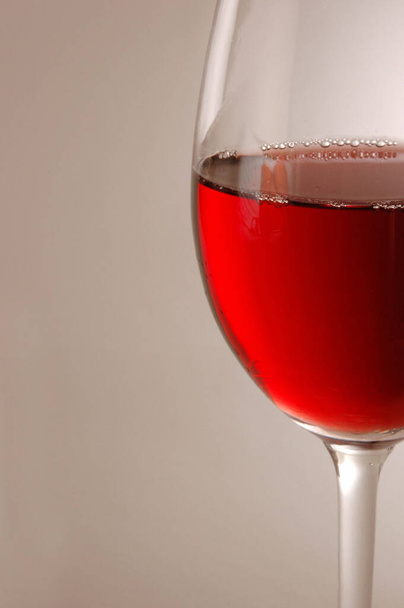 Wine glass containing red wine - Фото, изображение