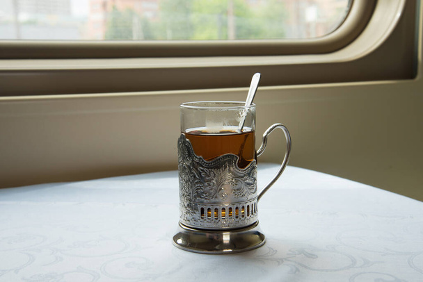 Russia, travel by train. Traditional tea in a beautiful Cup holder. - Φωτογραφία, εικόνα