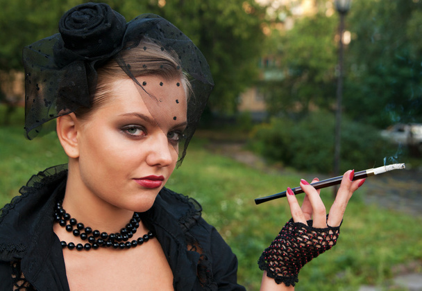 Portrait of young beautiful woman with cigaret in veil - Zdjęcie, obraz
