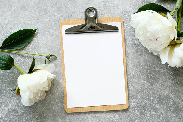 Clipboard mockup with peonies on concrete stone background. Flat lay, top view. Wedding planner, to do list, checklist concept. - Photo, image