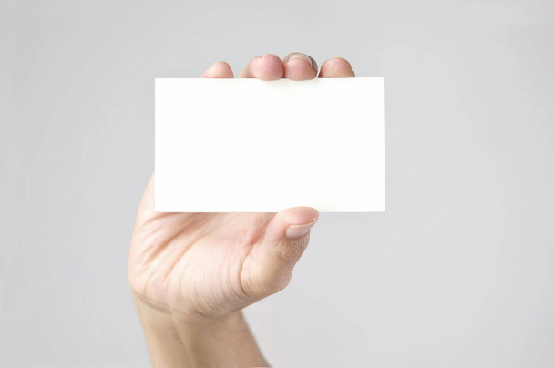 Hand holding empty card mockup  - Фото, изображение