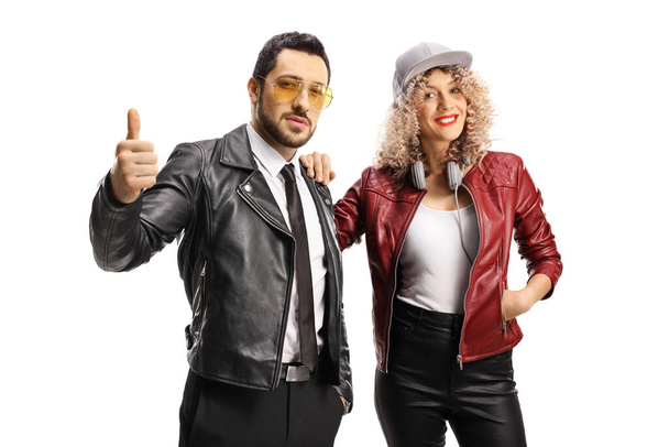 Young trendy couple in leather jackets showing thumbs up isolated on white background - Foto, Bild