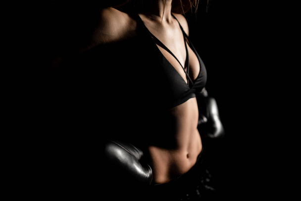 Female boxer training in the dark ring. Slow motion. Silhouette. Boxing concept. Fighter woman fist close up. Spectator video boxing. Smiling girl boxing at fitness gym in gloves. - Φωτογραφία, εικόνα
