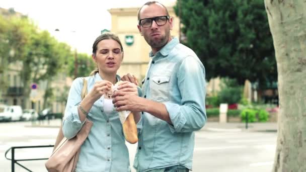 Attractive couple eating baguette - Кадри, відео