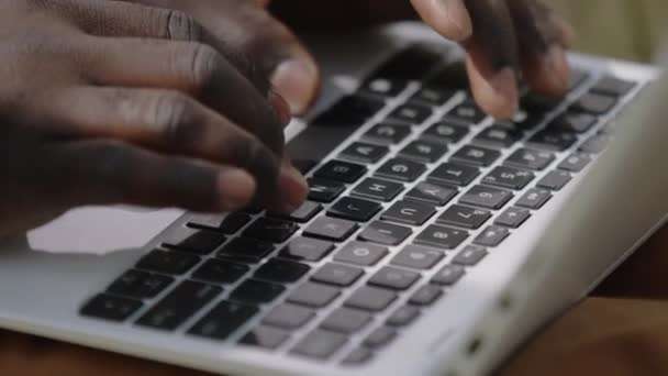 Close up, hands of an african man using laptop - Imágenes, Vídeo