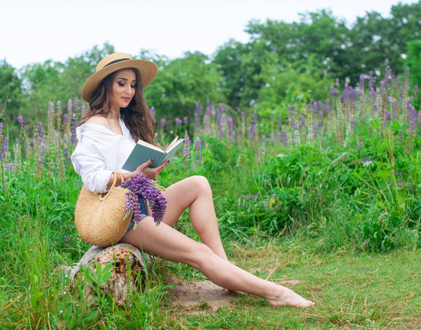 Pretty attractive girl reading book relax on nature field of flowers - Foto, Imagem