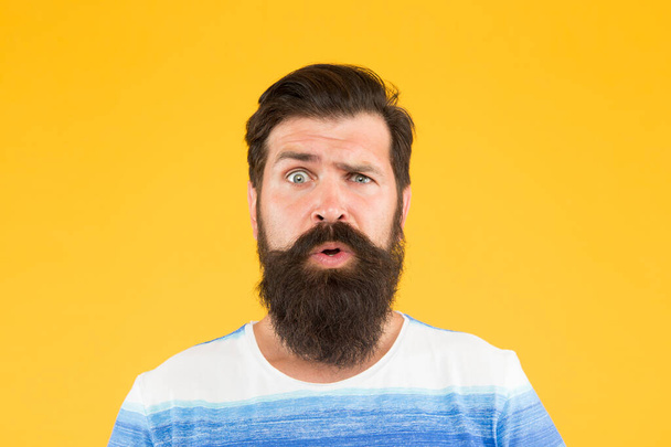 Hair care and skincare. amazed brutal bearded man on yellow backdrop. handsome confident man has perfect hairdo. male facial care. portrait of brutal bearded man. serious stylish man with moustache - Foto, Imagen