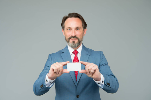 confident man in smart wear hold card. showing his business card. expert in legal affairs. mature general manager. male business executive. contact me please. man with debit card - Fotoğraf, Görsel