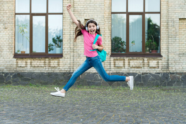 Energetic drive. Happy child in energetic jump outdoors. Energetic mood. Music and entertainment. School holidays. Summer vacation. Healthy and energetic - Zdjęcie, obraz