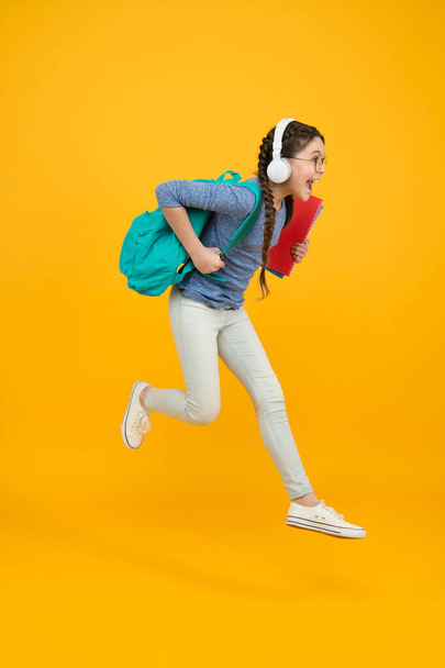 Chase your dream. Energetic kid hurry to school. Happy child in energetic jump yellow background. Energetic mood. Healthy and energetic. School essentials. Hie yourself to back to school sale - Valokuva, kuva