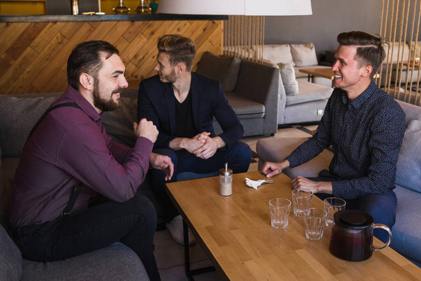 Men drink tea in a stylish loft cafe with a modern design - Фото, зображення