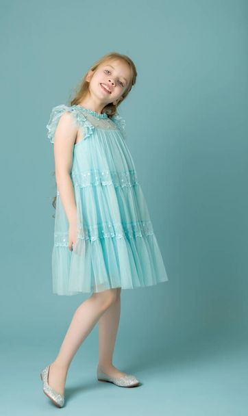 Elegant girl in a dress. Youth fashion concept, happy child. - Zdjęcie, obraz
